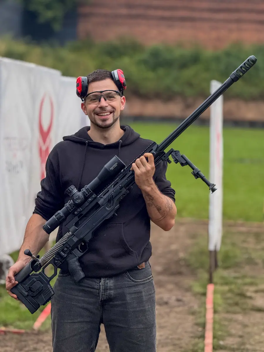 Shooter holding a .50 BMG sniper rifle at Poland Shooting Center