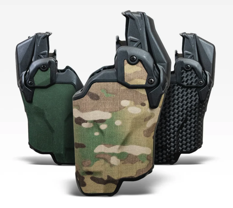 Three Blade-Tech Valor duty holsters in Multicam, Ranger Green, and black carbon-weave finishes, shown with Tek-Mount belt attachment hardware