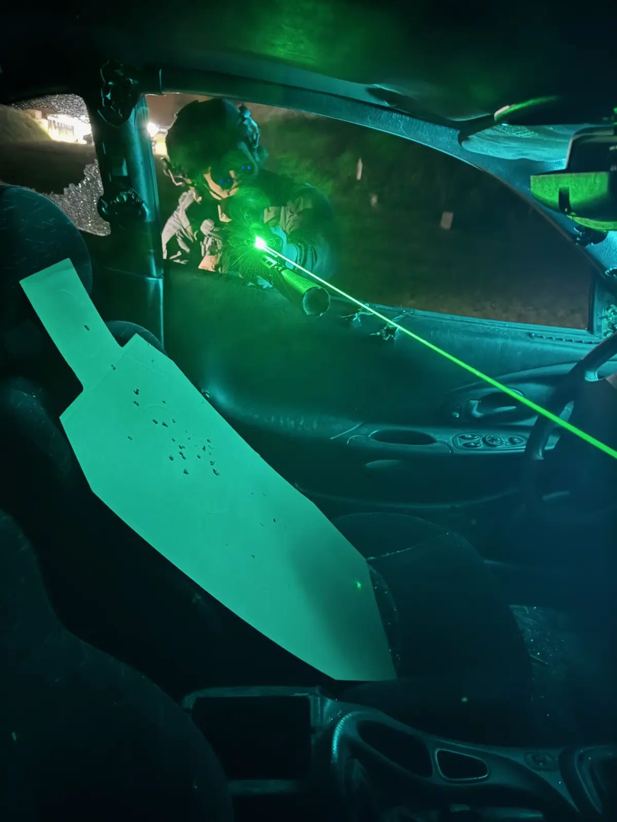 Green IR aiming laser during a night-vision shooting drill at Poland Shooting Center