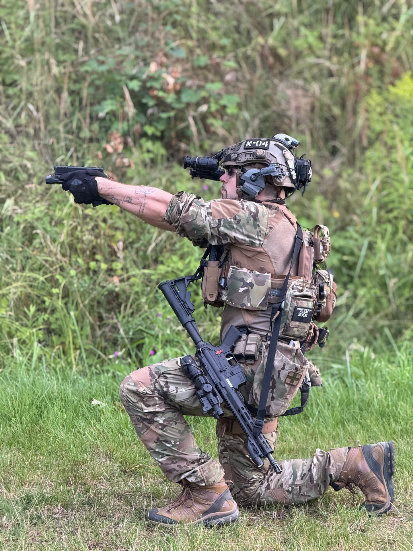 Shooter kneeling and firing a pistol during tactical training in Poland
