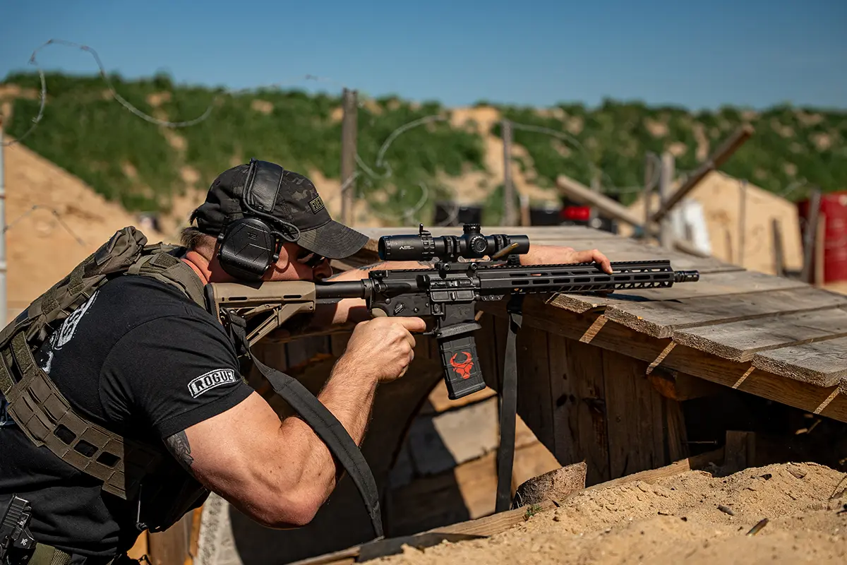 Tourist shooting an AR15 rifle under instructor supervision at a licensed Polish shooting range